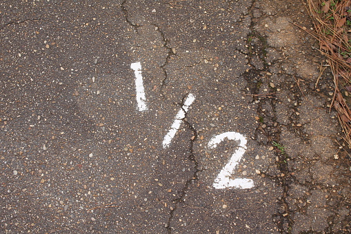 Numbers painted on concrete and asphalt textured surfaces