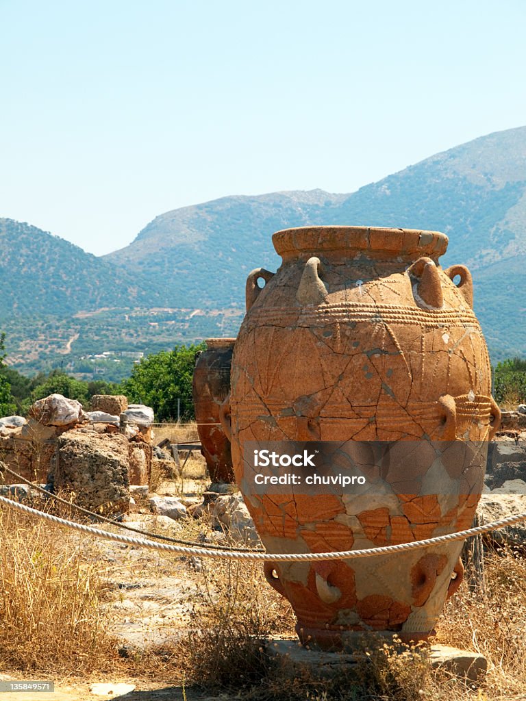 Pithos in the Malia Palace. Pithos in the Malia Palace. Crete, Greece. The palace of Malia, dating from the Middle Bronze Age, was destroyed by an earthquake during the Late Bronze Age; Knossos and other sites were also destroyed at that time. The palace was later rebuilt toward the end of the Late Bronze Age. Most of the ruins visible today date from this second period of construction.(Wikipedia). Amphora Stock Photo