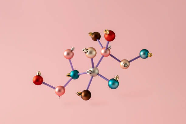 Colorful Christmas balls arranged in a chemical molecular structure. New Year's scientific minimal concept on pink background Colorful Christmas baubles arranged in a chemical molecular structure. New Year's scientific minimal concept on pink background neutron photos stock pictures, royalty-free photos & images