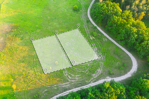 Land Plot for Housing on green field - aerial drone shot. Topographical Marking of two plots of Land for Private Residence House Construction. Land Plot plan Marking with white Overlay.