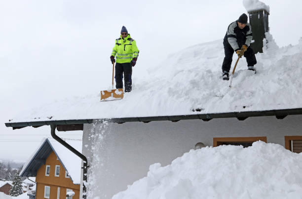 istock Two men shoveling high heavy snow from a house roof 1358502763