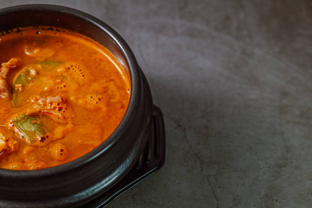 Cheonggukjang, Korean style rich soybean paste stew : A stew made with a thick soybean paste called cheonggukjang (similar to Japanese natto) with dubu (soybean curd / tofu), fully fermented kimchi, and pork. This paste is thicker and has a stronger smell