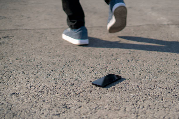 istock lost black smartphone outdoors laying on the ground 1358509335