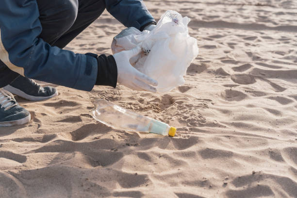 istock global environment problems conversation, person holding garbage outdoors, cleaning our ecosystem 1358509624