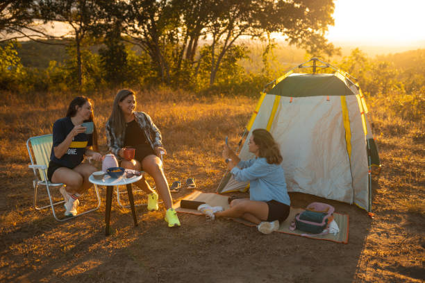 istock Women camping at sunset 1358510268