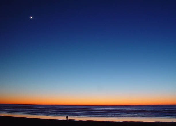 istock Beach Sunset with moonlight and couple 135851688
