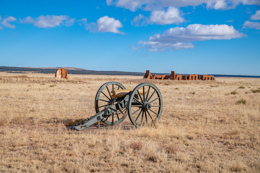 Wide view Fort Union preservation with cannon in New Mexico exposed to the wind, within a sweeping valley of short grass prairie, amid the swales of the Santa Fe trail, is the remnants of the largest 19th century military fort in the region of New Mexico, in southwest USA.