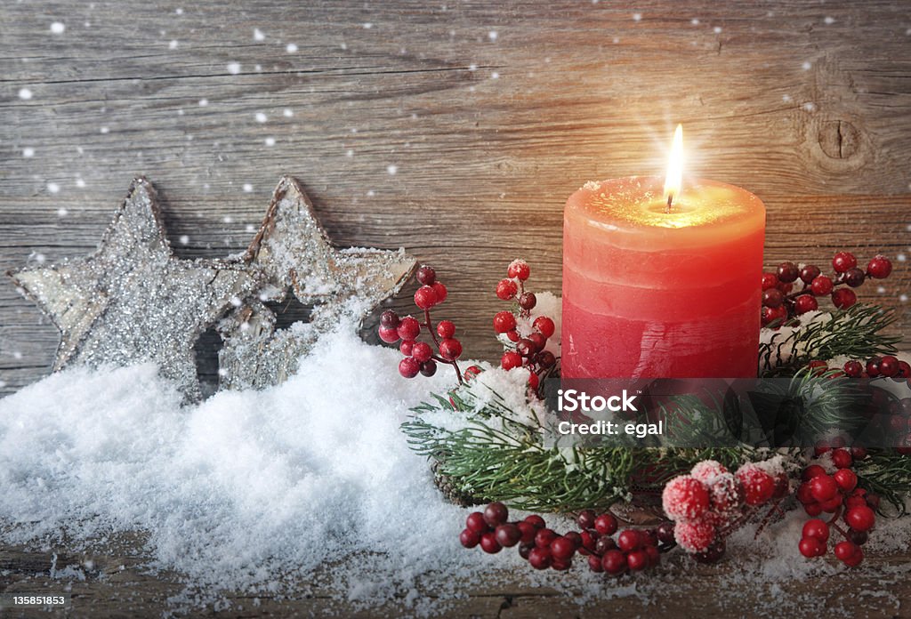 Burning candle Burning candle in the snow Burning Stock Photo