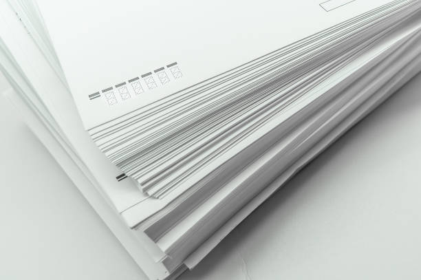 istock A stack of large white postal envelopes. Packaging for letters and documents. Postal supplies. Selective focus 1358519372