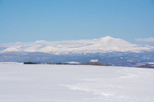 istock Snowfields and snowy mountains in early spring on a sunny day 1358524880