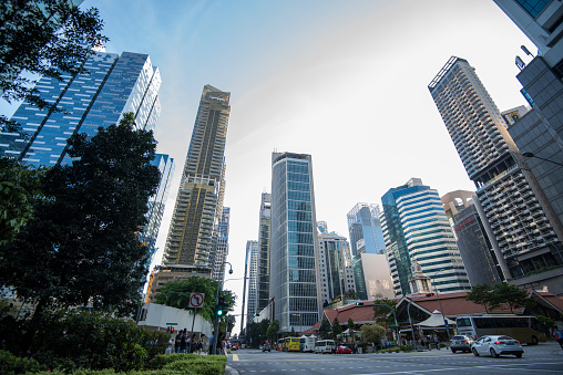 Singapore,09,12,2019, Low wide-angle view looking up to modern skyscrapers in business district on a beautiful sunny day with blue sky and clouds.