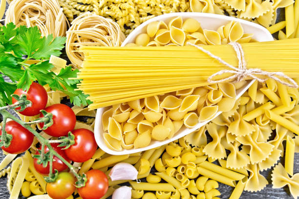 istock Pasta different with bowl and tomatoes on board top 1358535046