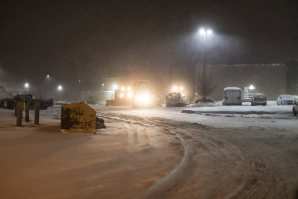 night blizzard snowplows in supermarket parking lot - snowplow snow parking lot pick up truck imagens e fotografias de stock