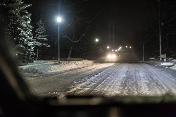 istock Approaching Snowplow Pickup Truck in Night Winter Blizzard 1358535430