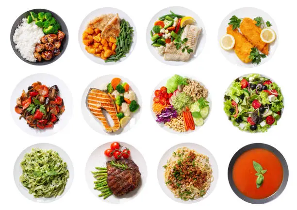 Photo of set of plates of food isolated on a white background