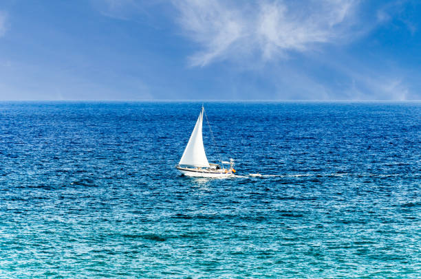 istock Small sailing ship in the sea 1358541400