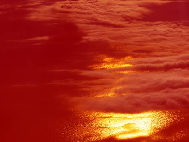 istock Red sunset sky clouds over golden sea. 1358542043