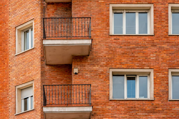 istock Residential brick building facade with balconies 1358542108
