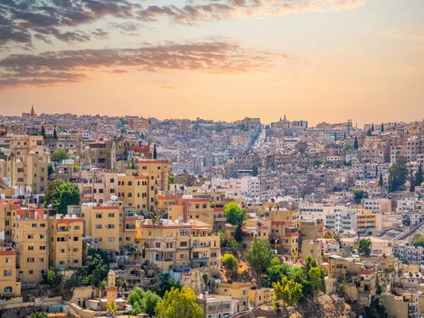 Photo of Beautiful view with many apartment buildings at sunset in Amman, Jordan.