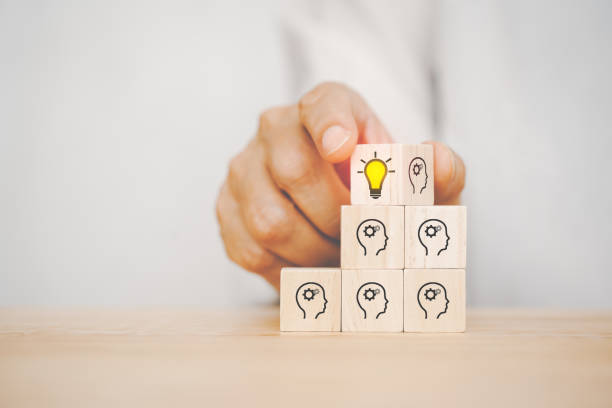 istock hand flip wooden cube, human's head to bright lightbulb, on stack of cube, creative idea , innovation, problem solving concept 1358542367