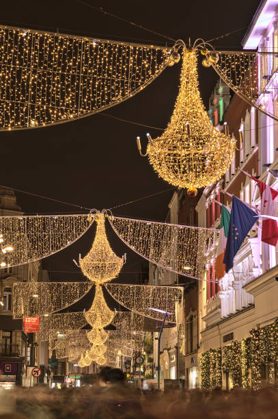 Christmas lights decorations on Grafton Street in Dublin Dublin, Ireland - November 13, 2021: Beautiful closeup evening view of Christmas lights decorations on Grafton Street. Crowded street during COVID pandemic. Irish Christmas long exposure winter crowd blurred motion stock pictures, royalty-free photos & images