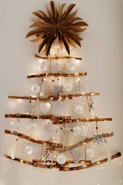 istock A sustainable Christmas tree wall hanging decoration on white wall. 1358545164