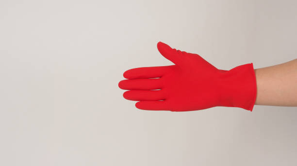 istock Right Hand wearing red latex gloves on white background. 1358545356