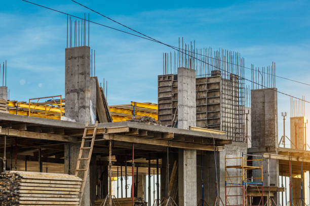 istock Extensive scaffolding providing platforms for work in progress on a new apartment block,Tall building under construction with scaffolds,Freestanding tower crane on a building site 1358545397
