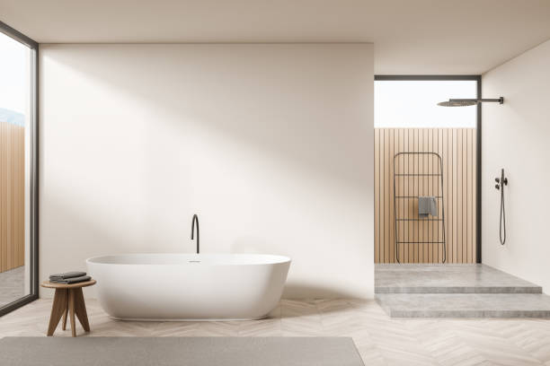 istock Light bathroom interior with bathtub and table, douche on podium. Mockup 1358547265