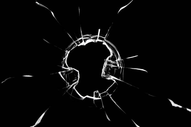 istock broken cracked glass with big hole over black background 1358547277