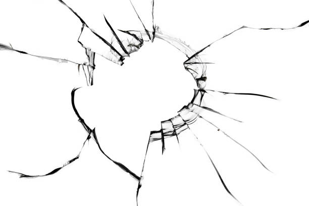 istock Texture of cracks on the glass. A hole in a broken window 1358547309