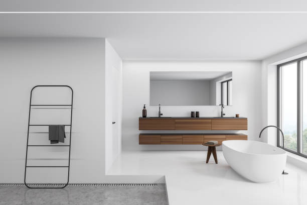 istock Bright bathroom interior with bathtub, panoramic window with countryside view 1358547312