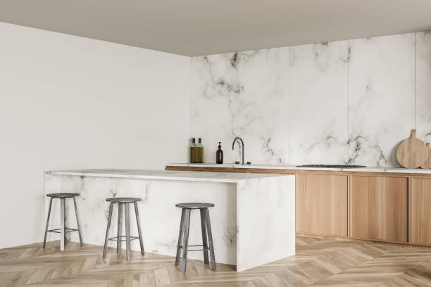 istock Corner of minimalist white marble kitchen with breakfast bar 1358548495
