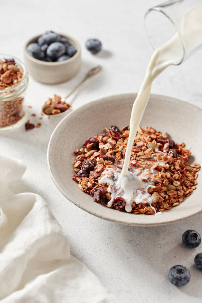 istock breakfast with granola, milk and berries on a bright table 1358548506