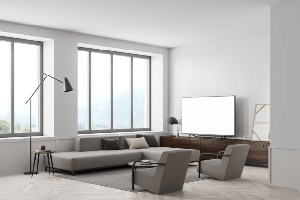 istock Living room interior with sofa and seats, window and television mockup screen 1358548640