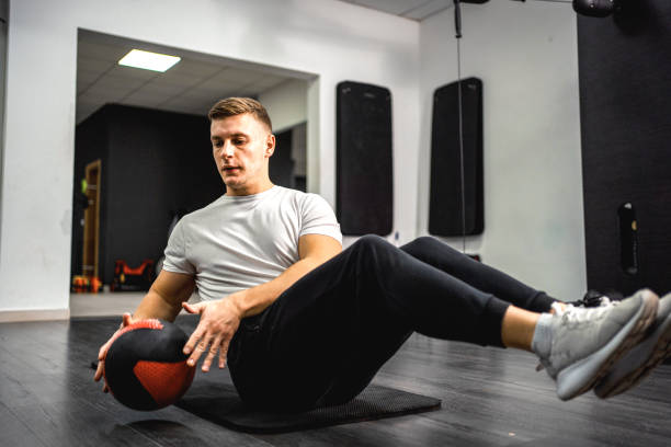 istock Athletic young man training abs in the gym 1358548854