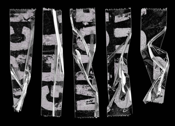 transparent adhesive tape or strips isolated on black background with alphabet letters
