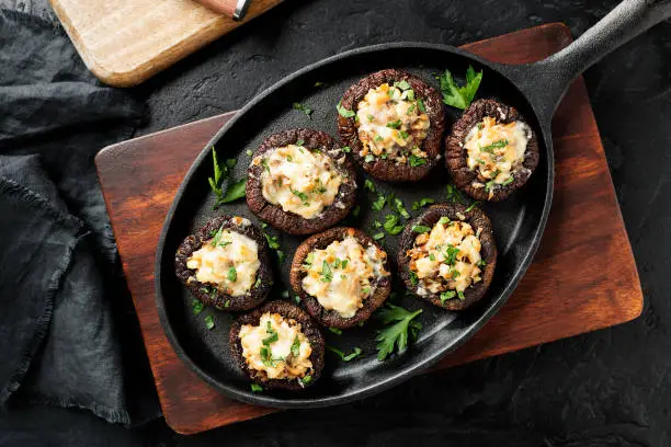 Baked mushroom caps stuffed with chicken meat, parmesan cheese, garlic and herbs. top view