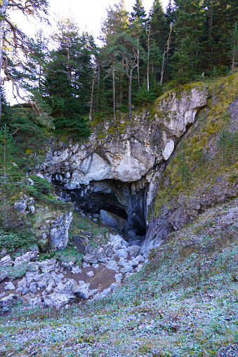 Rock cave with hole through which light shines. Underworlds in Sweden. Mystical atmosphere. Nature shot from Scandinavia