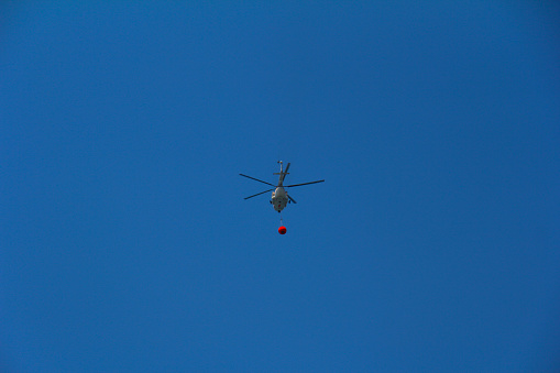 Firefighting Helicopter Carrying a Water Bucket, Turkey.