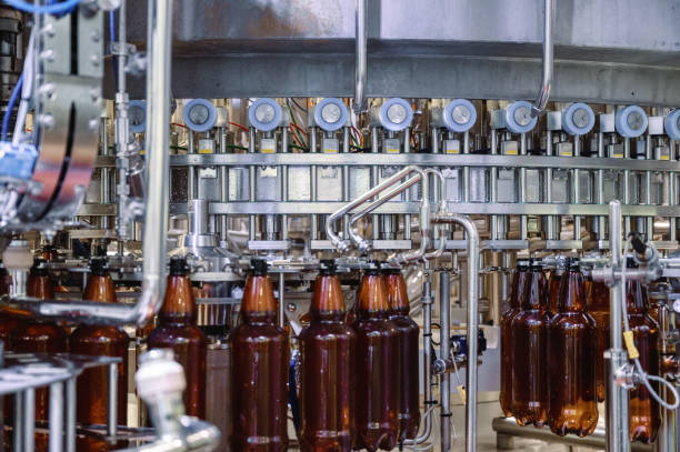 istock Large filling machine, the process of filling plastic bottles with various drinks 1358554541