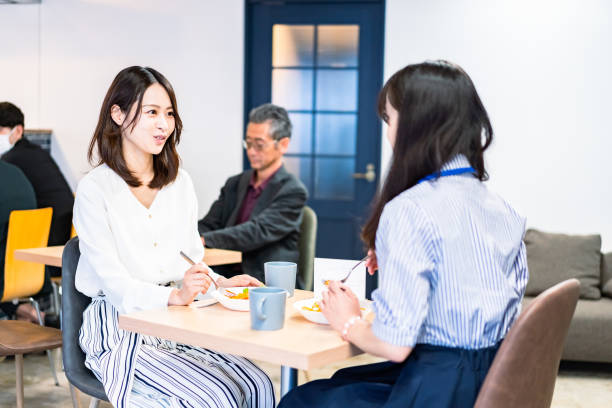 istock Office workers having lunch at a company cafeteria 1358558204