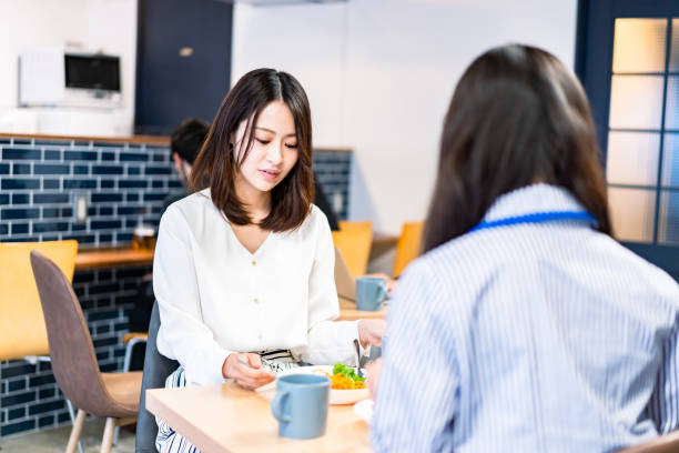 istock Office workers having lunch at a company cafeteria 1358558208