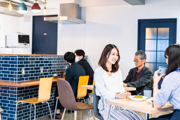 istock Office workers having lunch at a company cafeteria 1358558213