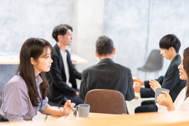 istock Office workers having lunch at a company cafeteria 1358558214
