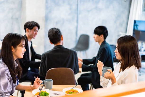 Office workers having lunch at a company cafeteria