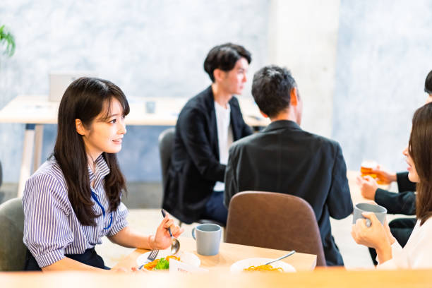 istock Office workers having lunch at a company cafeteria 1358558216