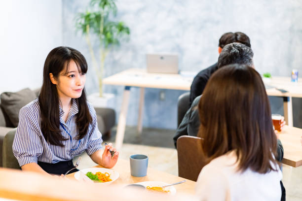 istock Office workers having lunch at a company cafeteria 1358558217