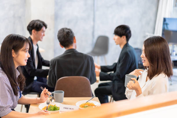 istock Office workers having lunch at a company cafeteria 1358558218