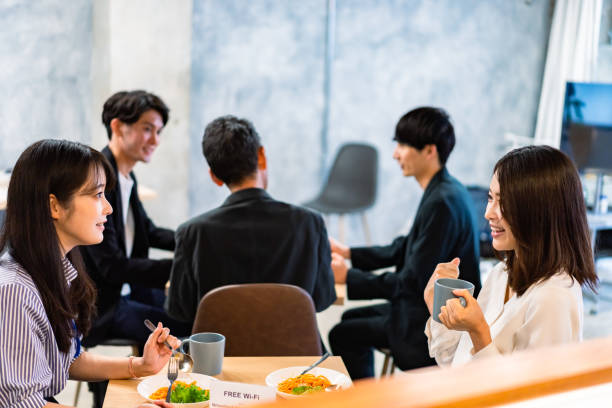 istock Office workers having lunch at a company cafeteria 1358558219